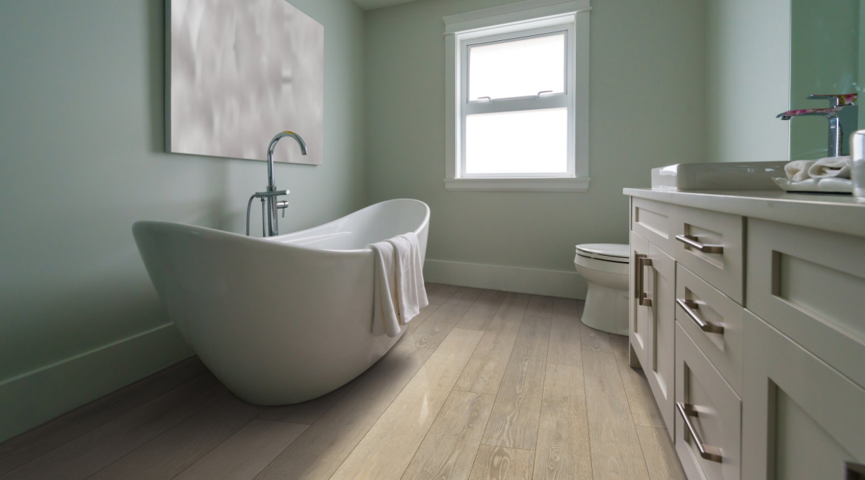 IDG bathroom scene featuring white clawfoot tub, green walls, and luxury vinyl planking 