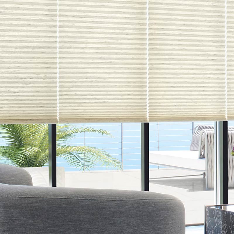 Dark brown window shades with red plant on top of a white table