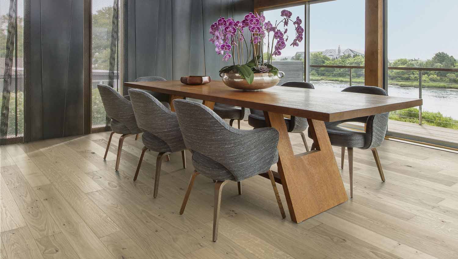 Dining room scene with oak hardwood flooring and purple flowers