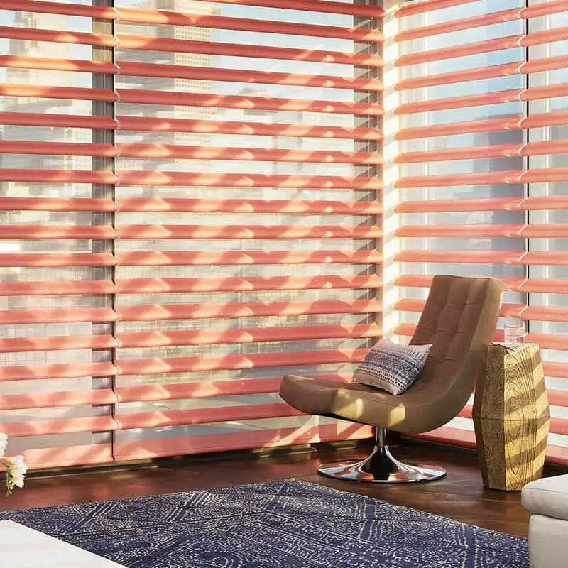 red window shades with brown chair